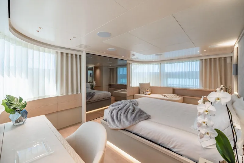 Legacy Yacht Photos Pics Luxurious bedroom interior of 2022 Sanlorenzo SD96 yacht, featuring elegant decor and natural light.