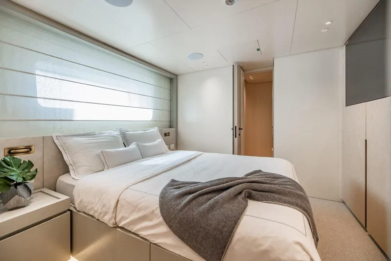Legacy Yacht Photos Pics Luxurious bedroom interior of 2022 Sanlorenzo SD96 yacht with modern design and cozy bedding.