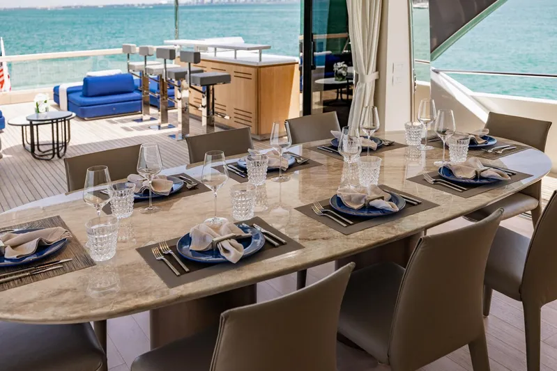 Legacy Yacht Photos Pics Luxurious dining setup on 2022 Sanlorenzo SD96 yacht with ocean view.