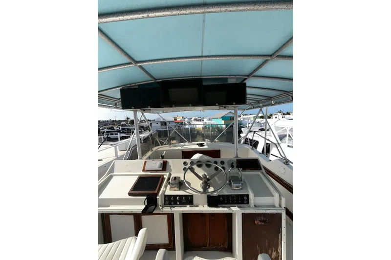  Yacht Photos Pics 1978 Hatteras 53 Yacht Fisherman helm with blue canopy and steering wheel.