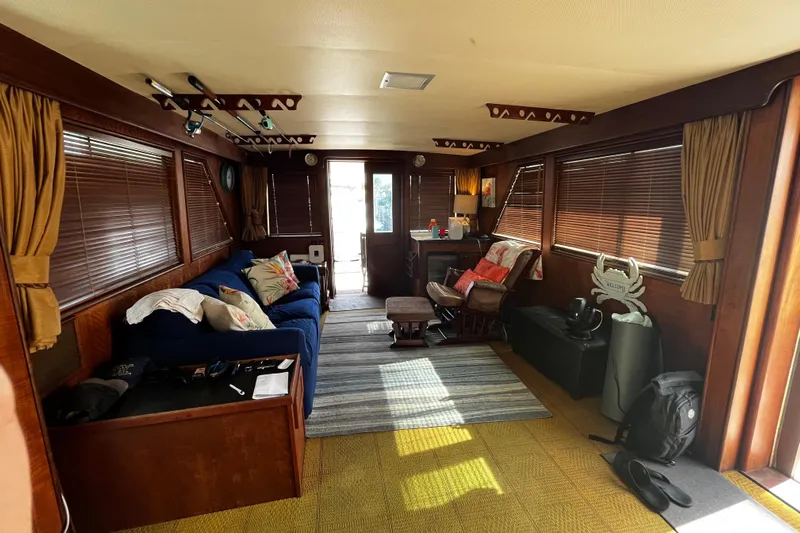  Yacht Photos Pics Interior of a 1978 Hatteras 53 Yacht Fisherman with cozy seating and wooden decor.