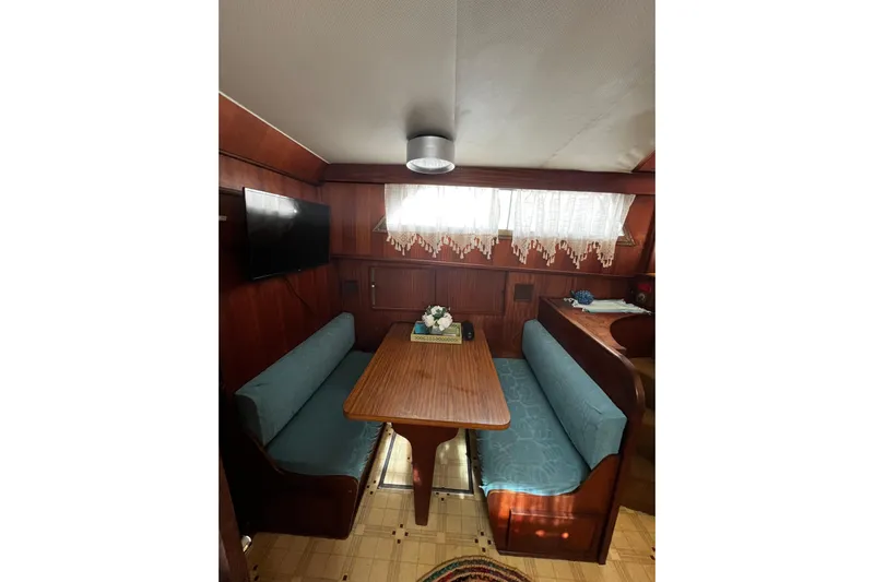  Yacht Photos Pics Interior of 1978 Hatteras 53 Yacht Fisherman with cozy dining area and wooden furnishings.