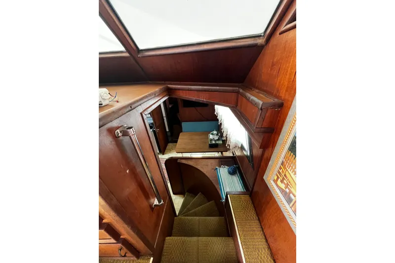  Yacht Photos Pics Interior view of 1978 Hatteras 53 Yacht Fisherman, featuring wooden stairs and cozy cabin space.