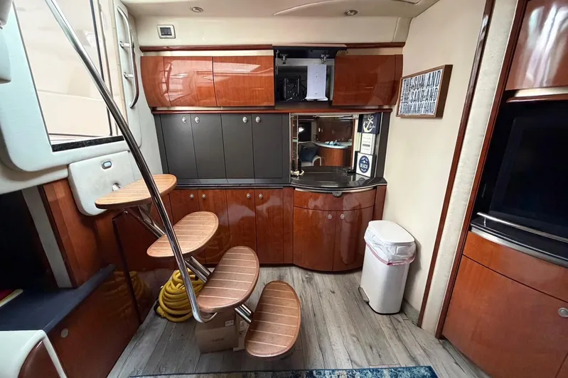 Galaxsea 500 Yacht Photos Pics Luxurious interior of a 2004 Sea Ray 500 Sundancer yacht with wooden cabinetry and spiral staircase.