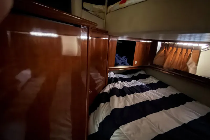 Galaxsea 500 Yacht Photos Pics Luxurious cabin interior of 2004 Sea Ray 500 Sundancer yacht with striped bedding.