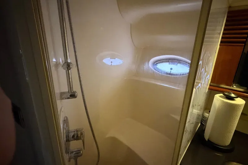 Galaxsea 500 Yacht Photos Pics Shower area inside 2004 Sea Ray 500 Sundancer yacht, featuring oval window and modern fixtures.
