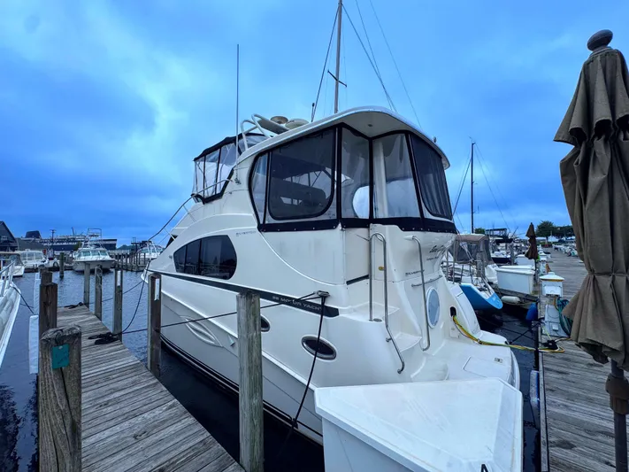  Yacht Photos Pics 2005 Silverton 35 Motor Yacht docked at marina under cloudy sky.