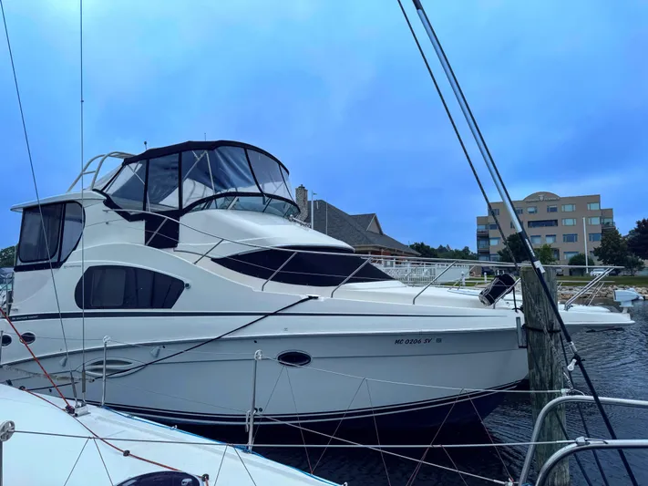  Yacht Photos Pics 2005 Silverton 35 Motor Yacht docked at marina under clear blue sky.