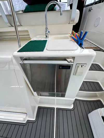  Yacht Photos Pics 2005 Silverton 35 Motor Yacht kitchenette with sink, mini fridge, and countertop accessories.