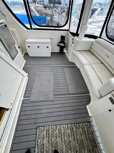 Yacht Photos Pics 2005 Silverton 35 Motor Yacht interior with seating, gray flooring, and marina view.