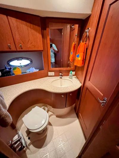  Yacht Photos Pics Bathroom interior of 2005 Silverton 35 Motor Yacht with wood cabinetry and modern fixtures.