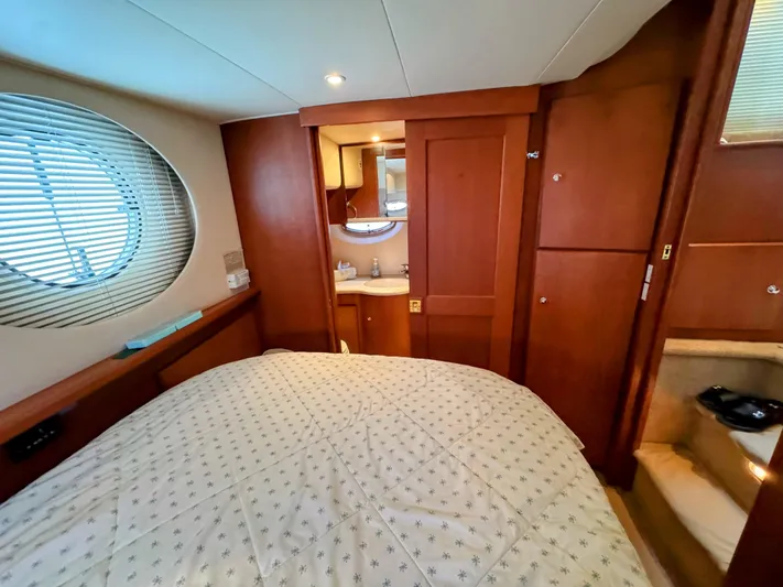  Yacht Photos Pics 2005 Silverton 35 Motor Yacht bedroom with wood paneling and round window.