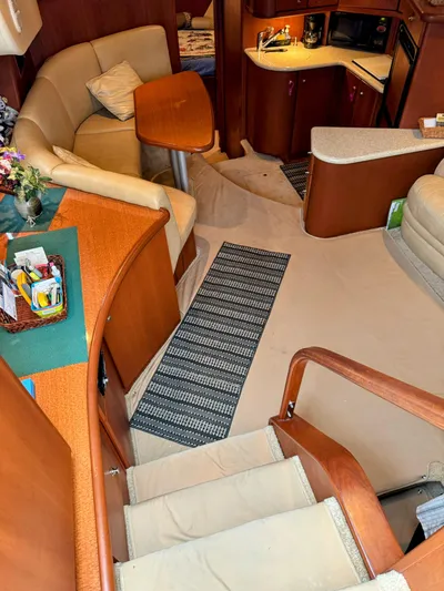  Yacht Photos Pics Interior of 2005 Silverton 35 Motor Yacht with cozy seating and compact kitchen area.