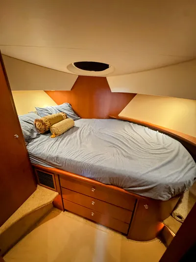  Yacht Photos Pics Cozy bedroom in 2005 Silverton 35 Motor Yacht with elegant wood finish and soft lighting.