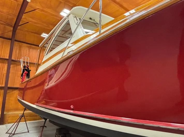 Lucy Yacht Photos Pics Red 2006 Ellis Express boat in wooden storage facility.