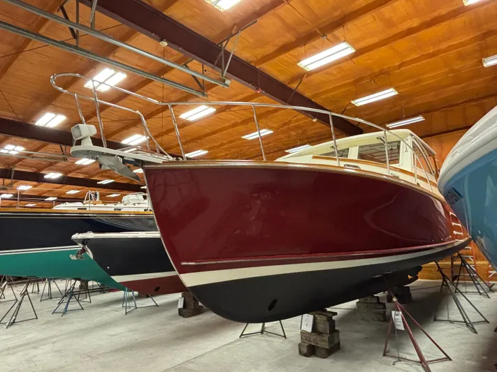 Lucy Yacht Photos Pics 2006 Ellis Express boat in indoor storage, red hull, elevated on blocks.
