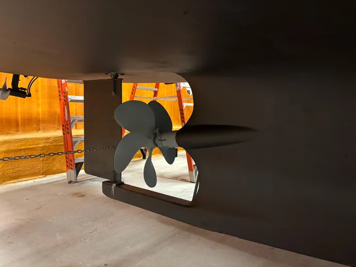 Lucy Yacht Photos Pics Propeller of 2006 Ellis Express boat in dry dock, with orange ladders in background.