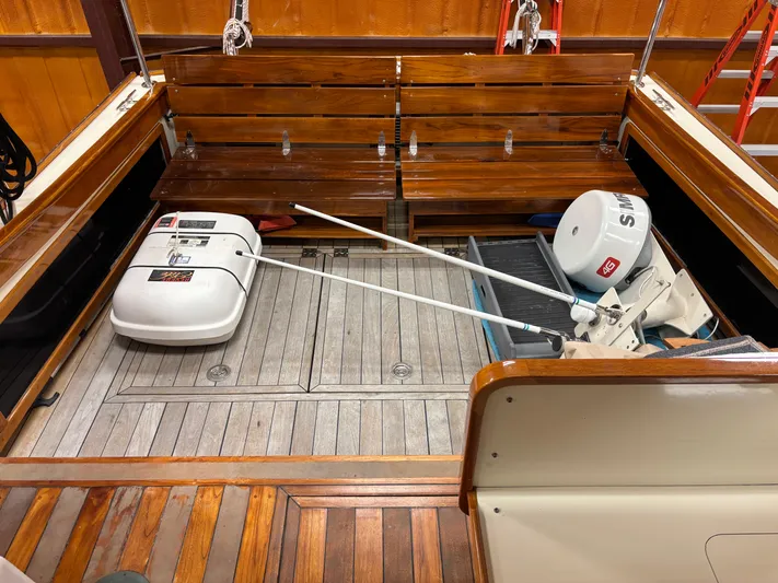 Lucy Yacht Photos Pics 2006 Ellis Express boat interior with wooden seating and equipment storage.