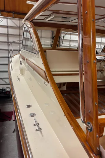 Lucy Yacht Photos Pics 2006 Ellis Express boat with wooden trim and sleek design in a garage setting.