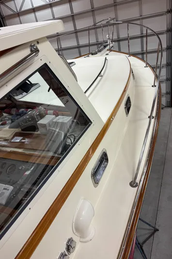 Lucy Yacht Photos Pics 2006 Ellis Express boat in a garage, showcasing sleek design and polished wood accents.