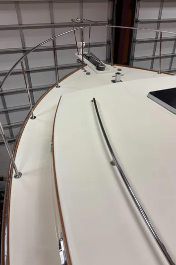 Lucy Yacht Photos Pics 2006 Ellis Express boat deck with metal railings in a garage setting.