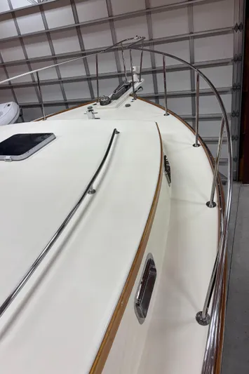 Lucy Yacht Photos Pics 2006 Ellis Express boat deck with stainless steel railings in a garage setting.