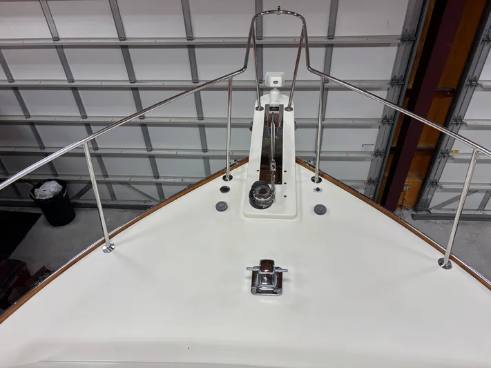 Lucy Yacht Photos Pics Bow of 2006 Ellis Express boat with stainless steel railings in a garage.