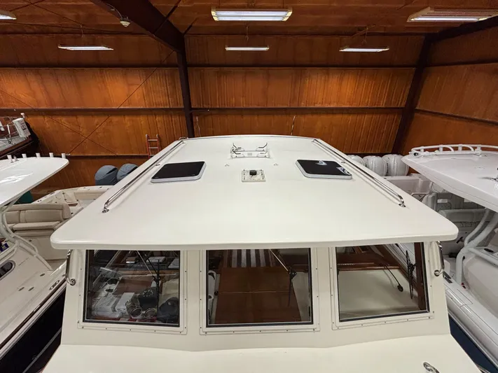 Lucy Yacht Photos Pics 2006 Ellis Express boat in indoor storage, showcasing roof and windows.