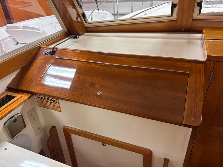 Lucy Yacht Photos Pics 2006 Ellis Express boat interior with polished wood finish and window view.