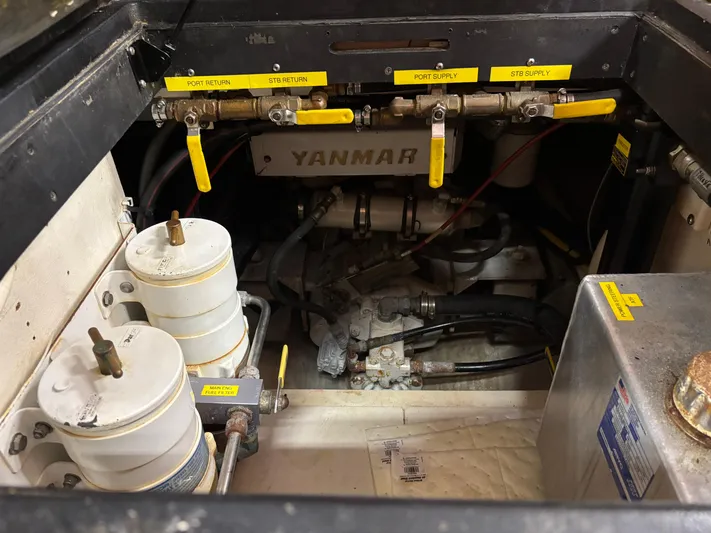 Lucy Yacht Photos Pics Engine compartment of a 2006 Ellis Express with Yanmar components and labeled fuel lines.