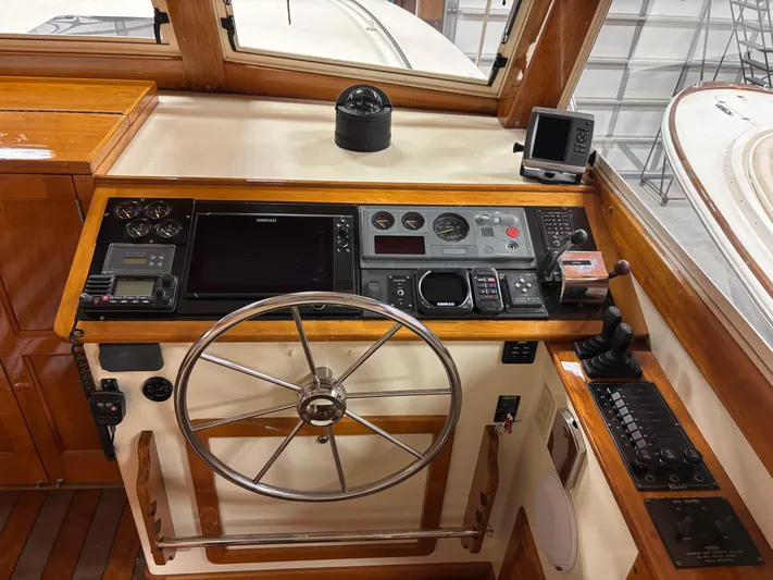 Lucy Yacht Photos Pics 2006 Ellis Express boat helm with navigation instruments and wooden accents.