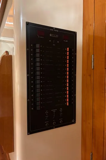 Lucy Yacht Photos Pics Electrical panel on a 2006 Ellis Express boat, mounted on a wooden wall.