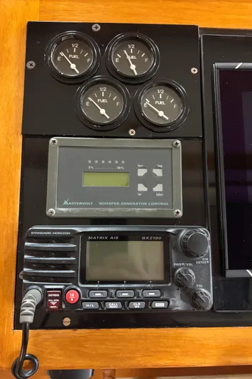 Lucy Yacht Photos Pics Control panel with fuel gauges, generator control, and radio on a 2006 Ellis Express.