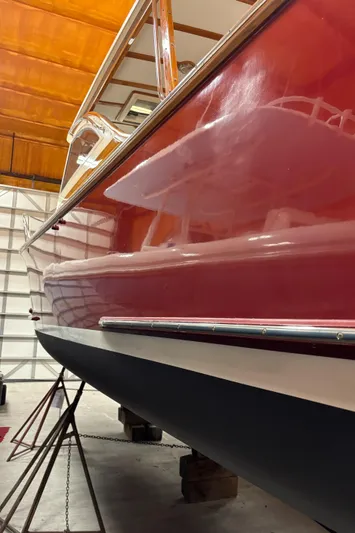 Lucy Yacht Photos Pics Red 2006 Ellis Express boat in storage, side view.