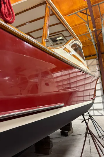 Lucy Yacht Photos Pics Red 2006 Ellis Express boat in storage, showcasing sleek design and vibrant color.