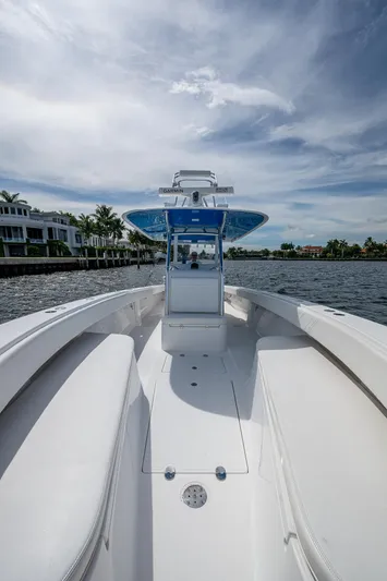 The Hogfather Yacht Photos Pics 2015 Bahama 41 boat on water, clear sky, luxury waterfront homes in background.
