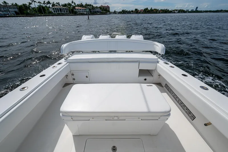 The Hogfather Yacht Photos Pics 2015 Bahama 41 boat interior with seating, on a sunny day, near waterfront homes.