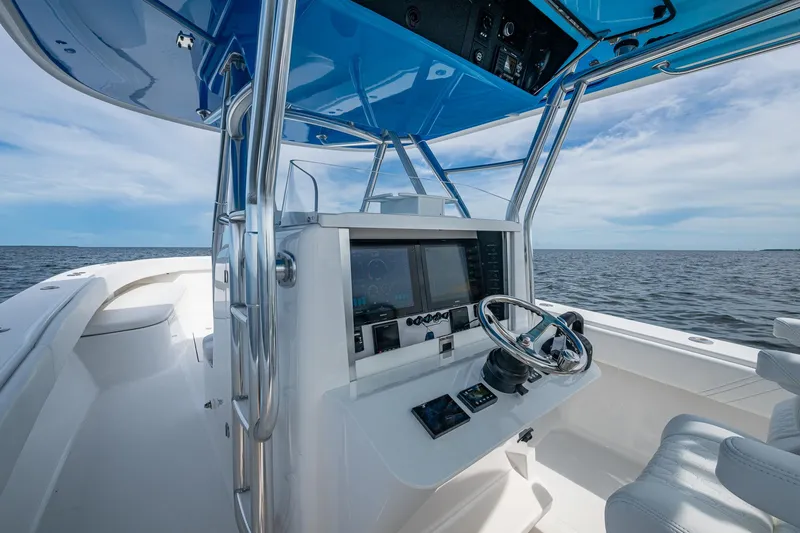 The Hogfather Yacht Photos Pics 2015 Bahama 41 boat cockpit with steering wheel and navigation system, under blue sky.