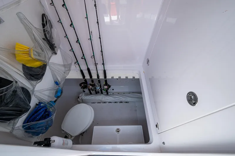 The Hogfather Yacht Photos Pics Interior of 2015 Bahama 41 boat with fishing rods, storage, and marine toilet.