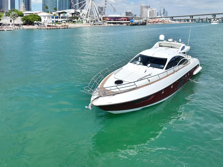 Warren Kelly Yacht Photos Pics Luxurious 2010 Azimut 62S yacht cruising in vibrant coastal waters.