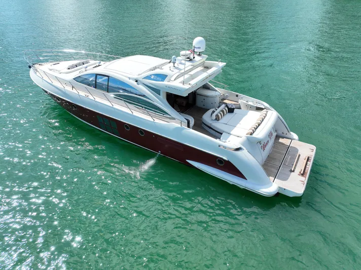 Warren Kelly Yacht Photos Pics Azimut 62S 2010 luxury yacht cruising on clear turquoise water.