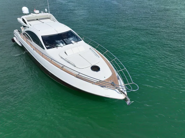 Warren Kelly Yacht Photos Pics Azimut 62S 2010 yacht cruising on clear green water, aerial view.