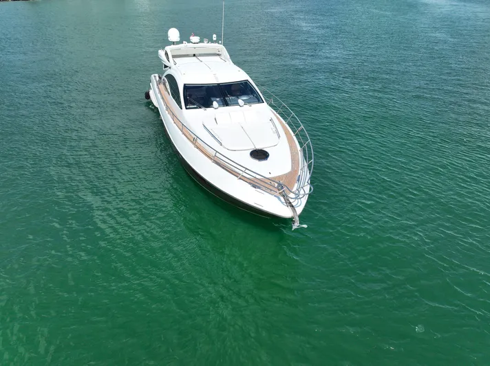 Warren Kelly Yacht Photos Pics Luxurious 2010 Azimut 62S yacht cruising on serene green waters.