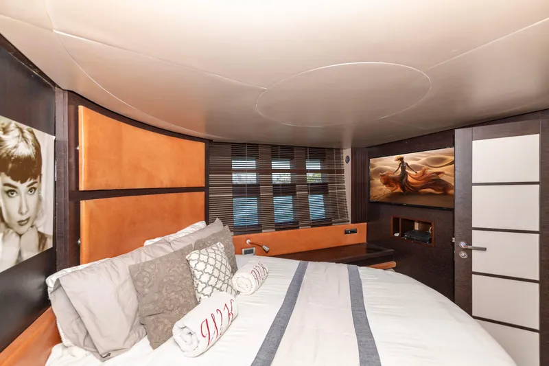 Warren Kelly Yacht Photos Pics Luxurious bedroom interior of 2010 Azimut 62S yacht with elegant decor and artwork.