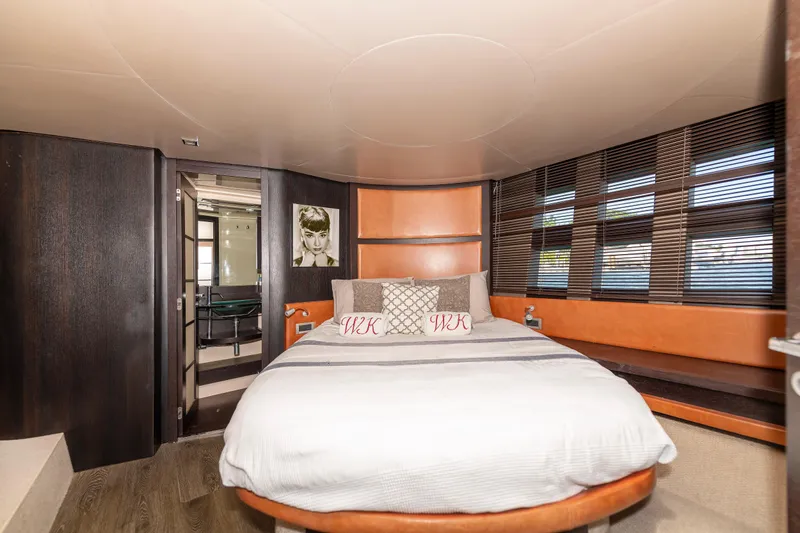 Warren Kelly Yacht Photos Pics Luxurious bedroom interior of 2010 Azimut 62S yacht with modern decor and large windows.