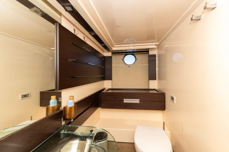 Warren Kelly Yacht Photos Pics Luxurious bathroom interior of 2010 Azimut 62S yacht with modern fixtures and porthole window.