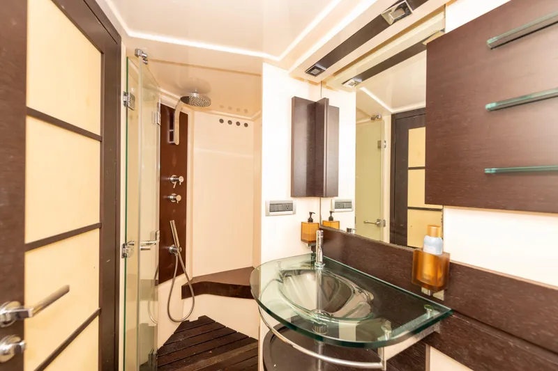 Warren Kelly Yacht Photos Pics Luxurious bathroom interior of 2010 Azimut 62S yacht with glass sink and modern shower.