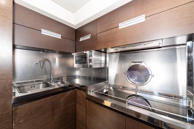 Warren Kelly Yacht Photos Pics Modern kitchen in 2010 Azimut 62S yacht with stainless steel appliances and wood cabinetry.