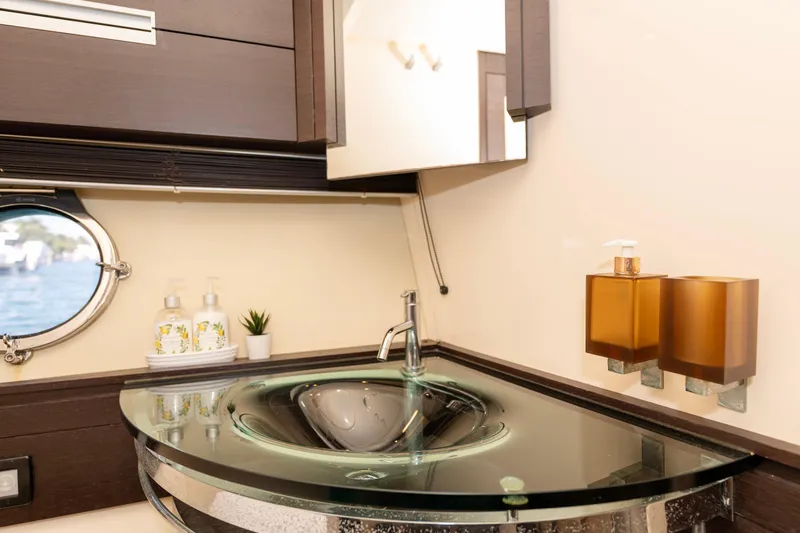 Warren Kelly Yacht Photos Pics Luxurious bathroom interior on a 2010 Azimut 62S yacht with modern glass sink.