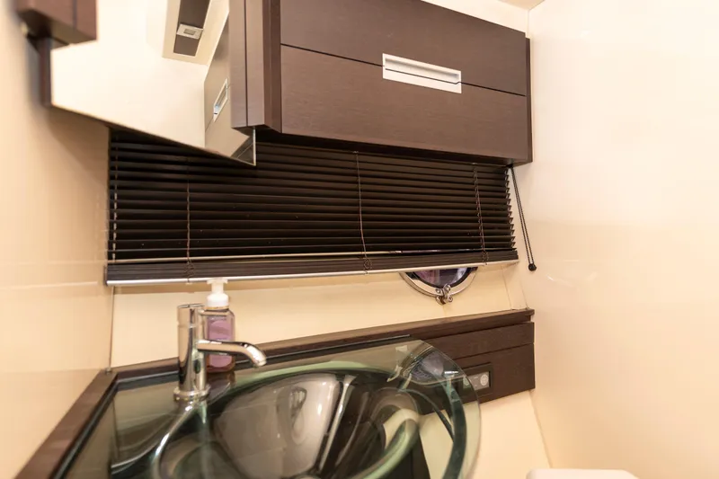 Warren Kelly Yacht Photos Pics Luxurious bathroom interior of 2010 Azimut 62S yacht with modern sink and cabinetry.